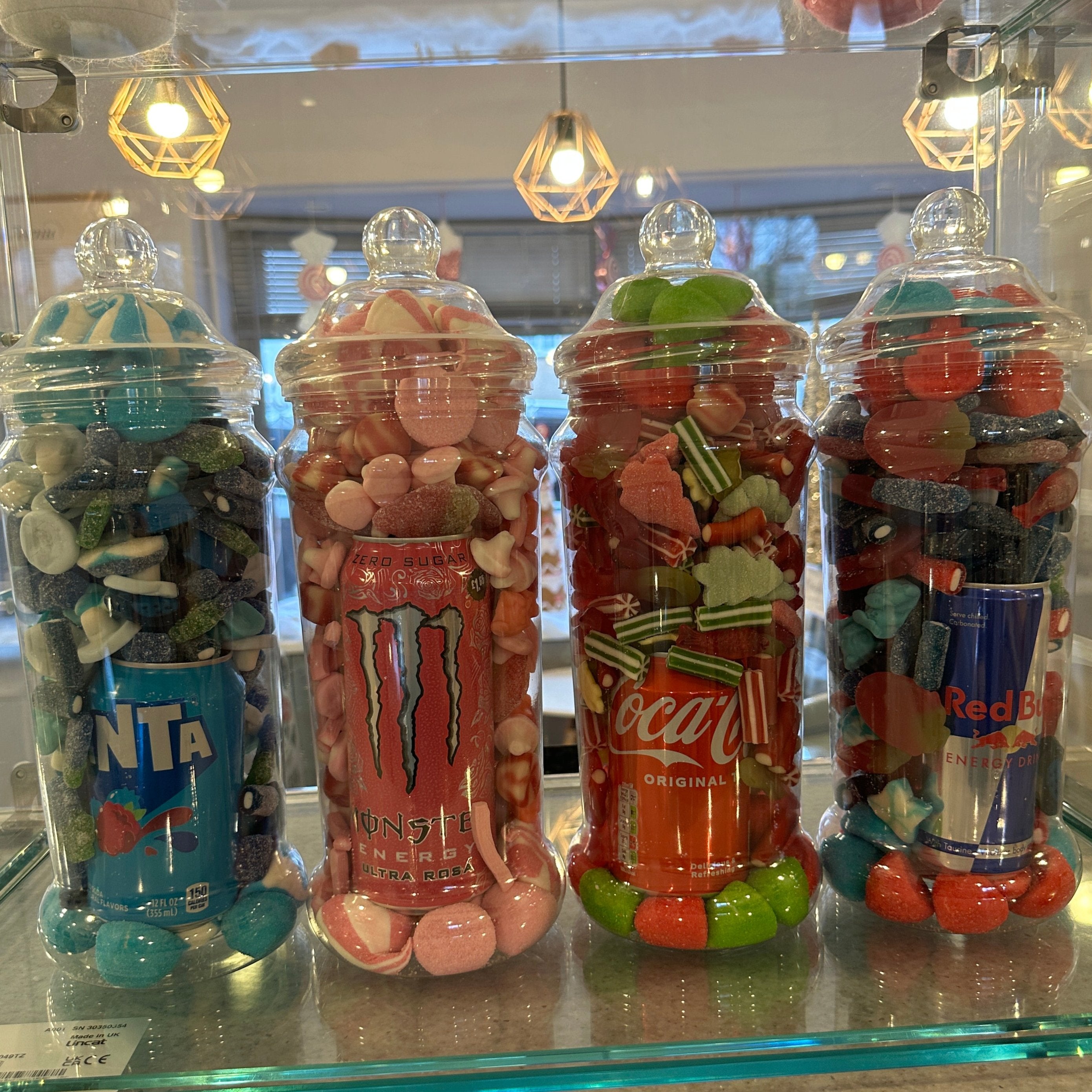 4 sweet jars on a shop counter
