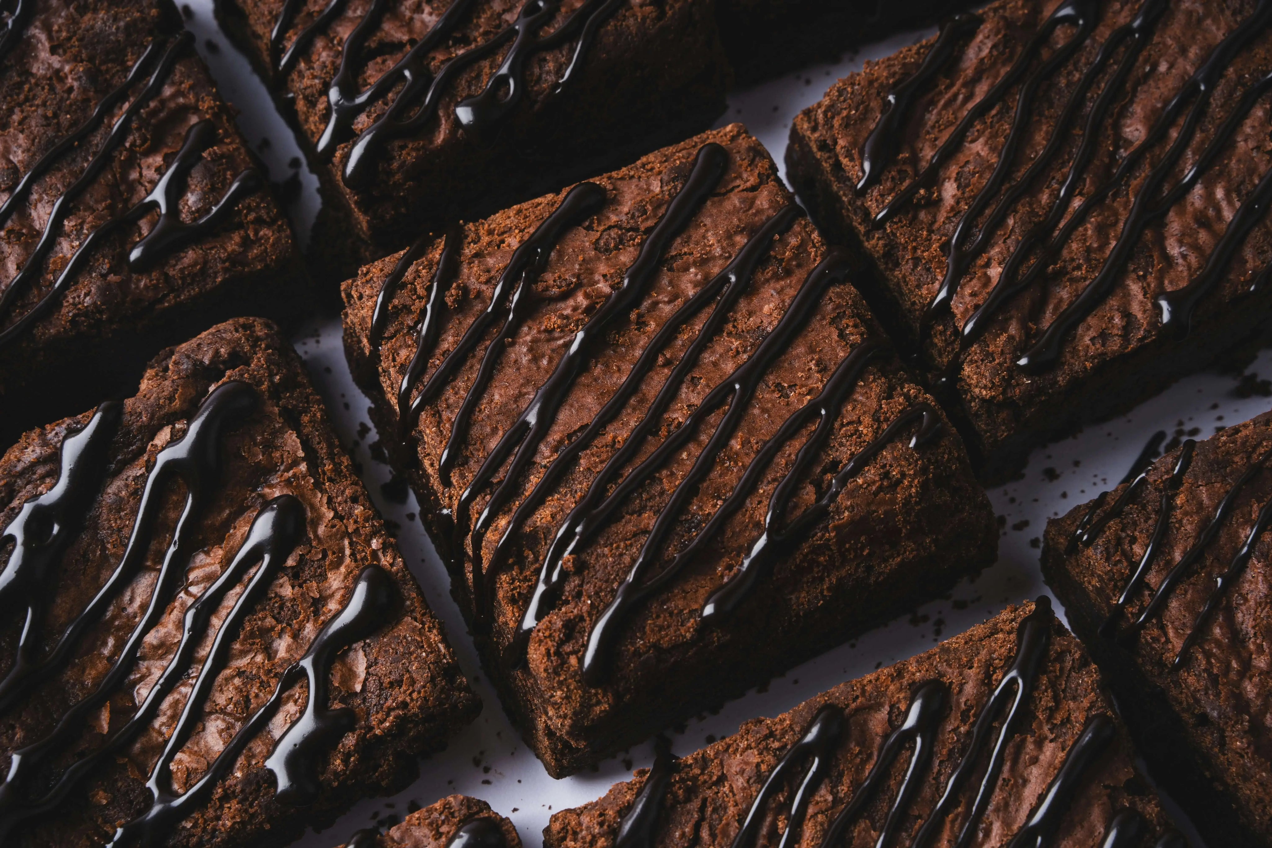 Rich brownies drizzled with chocolate